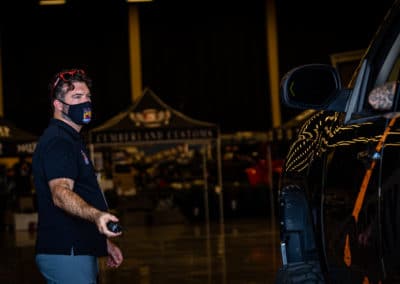 Jeep Invasion staff member directs vehicle into vendor area