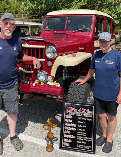2021 Award winner couple with crimson and cream colored classic Jeep