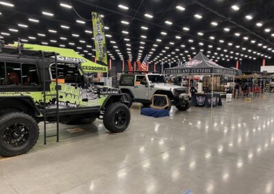 Main showroom area filled with vendors and Jeeps